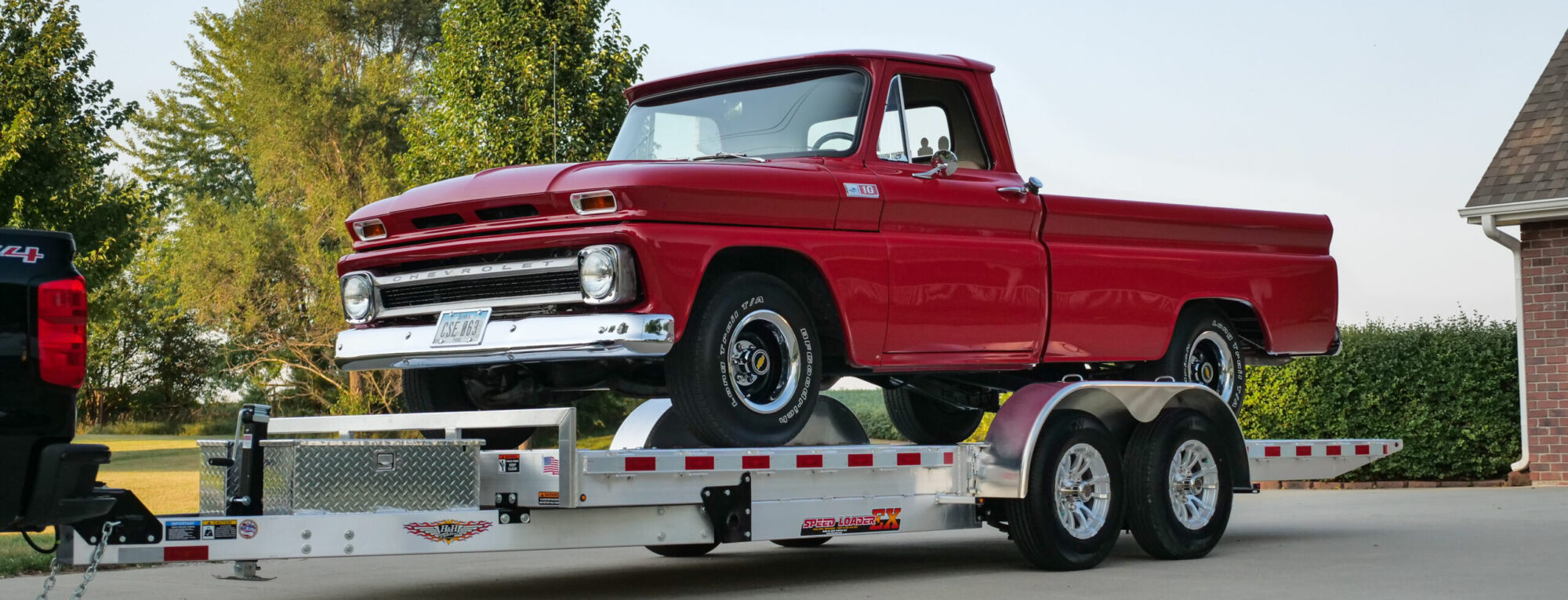 Truck towing a dump trailer at dusk